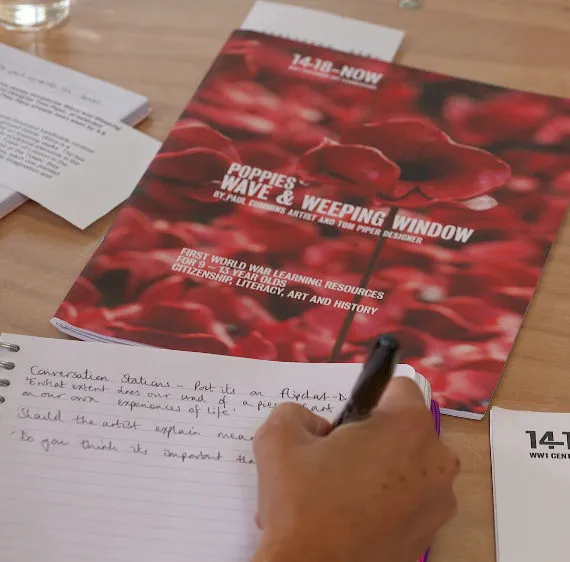 Brochure with a poppy cover on a desk.